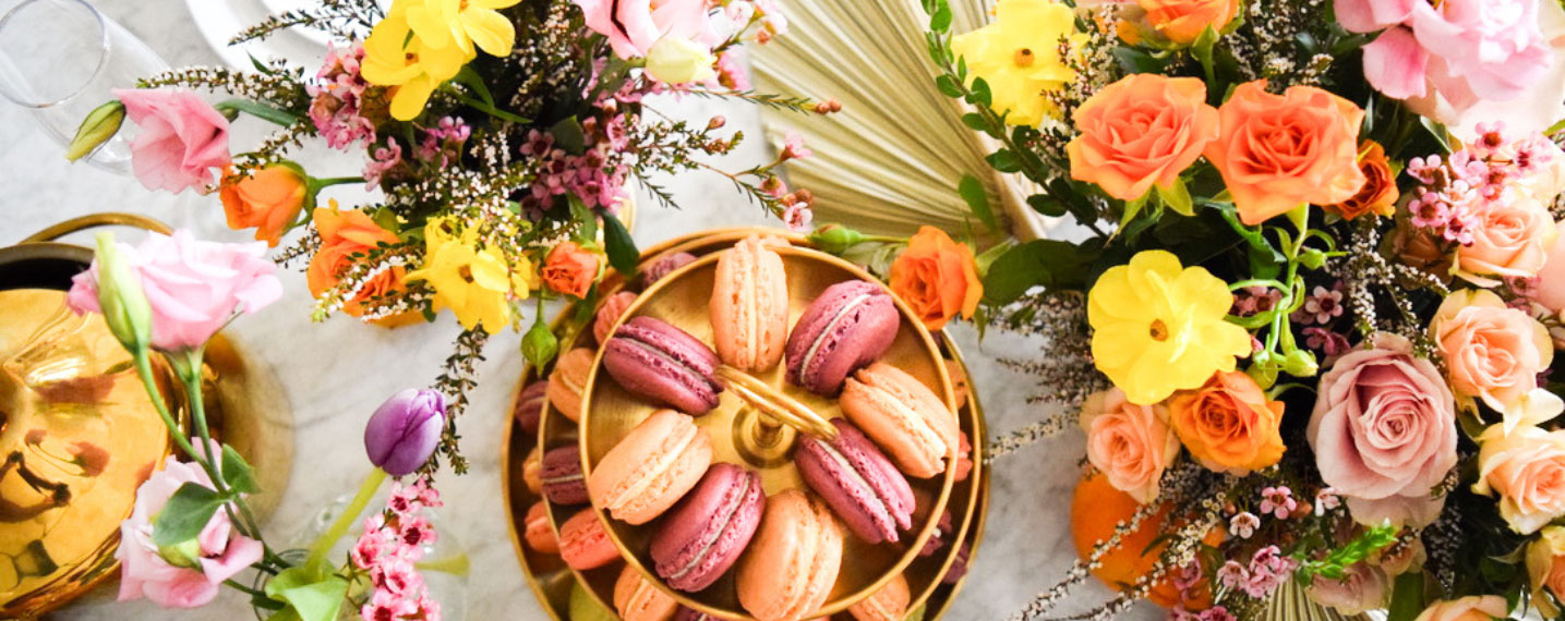 macaron tower with flowers on a table